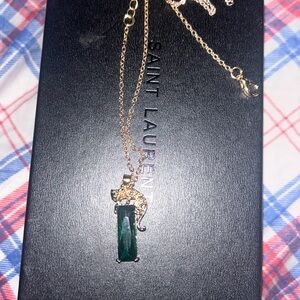 18 karat plated gold train with a green emerald